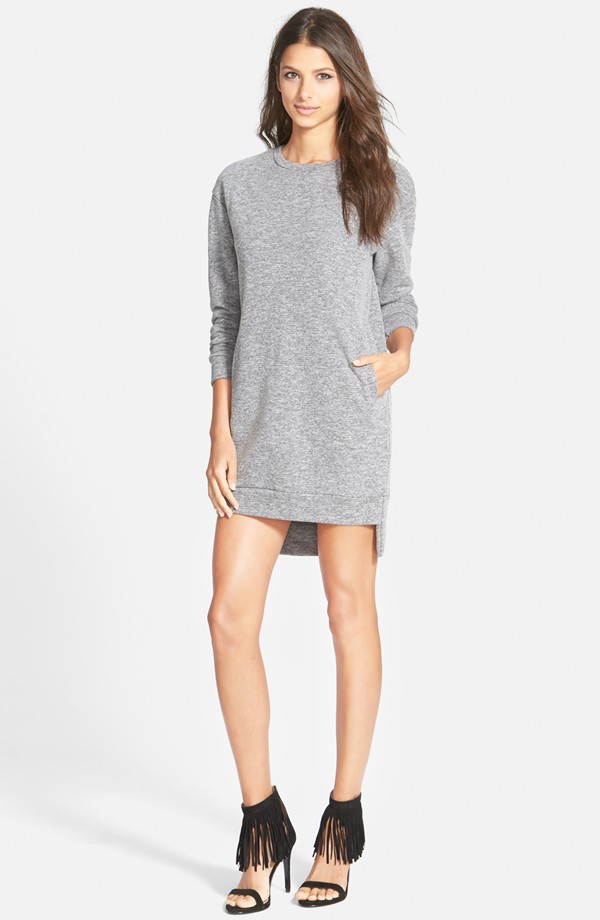 Dropped shoulders and a crisp step hem with side vents accentuate the oversized fit of a long-sleeve tunic dress cut from a soft cotton blend.  31 1/2